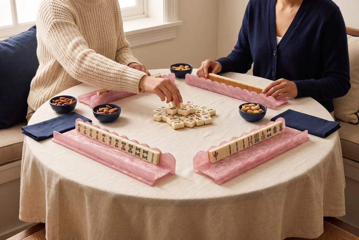 Two friends play mahjong across from each other at a small round table
