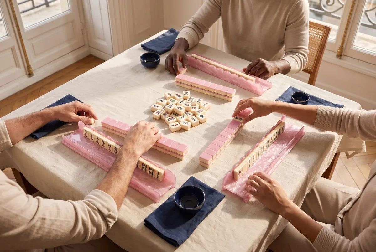 Three friends play mahjong at a square table with one side left empty