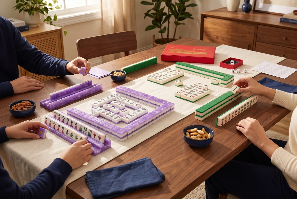A colorful American mahjong set with racks next to a classic Chinese set with green backs