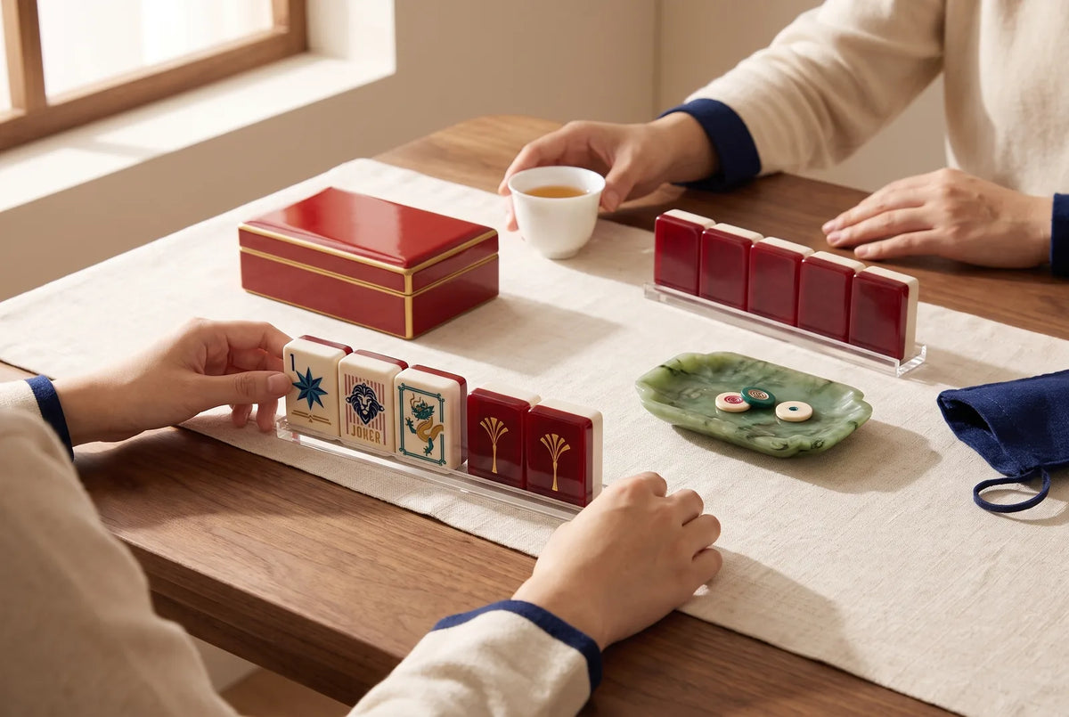 Mahjong tiles beside a red box, a green dish and a white cup, the three dragon colors