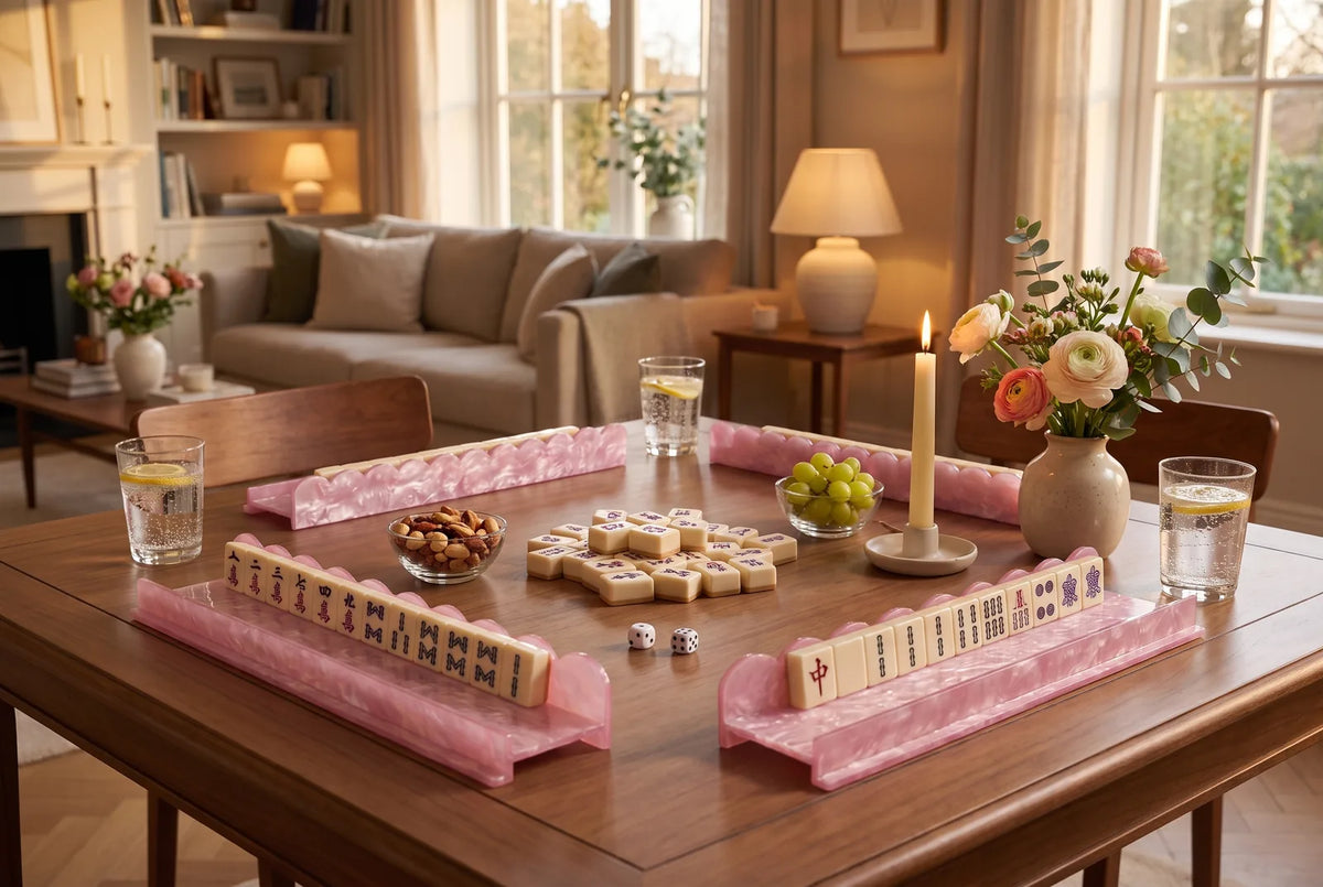 A cozy mahjong night at home with pink racks, tiles and drinks on the table