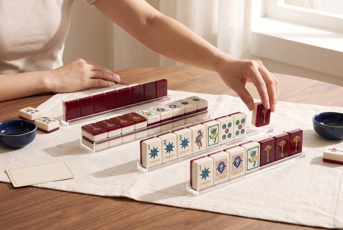 A player places a tile on a group of matching tiles on top of her rack