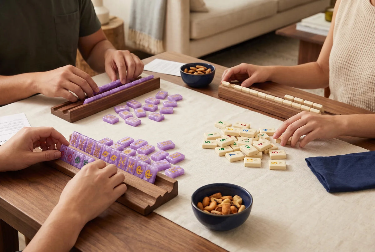 A mahjong set and a set of number tiles on the same table, ready to compare