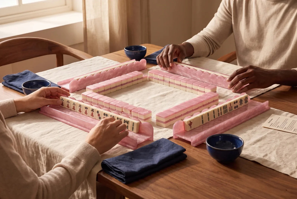 Two players face each other across a mahjong table, each with two racks of tiles