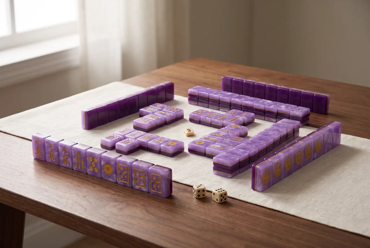 A full American mahjong set with purple marbled tiles laid out in neat rows on a wooden table